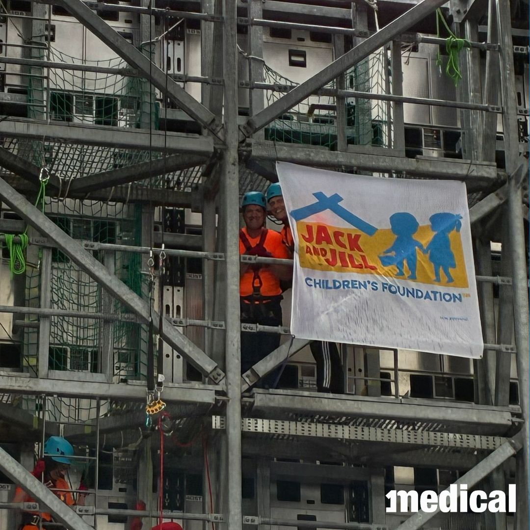 Abseiler with the Jack and Jill Foundation flag on the scaffolding at Croke Park